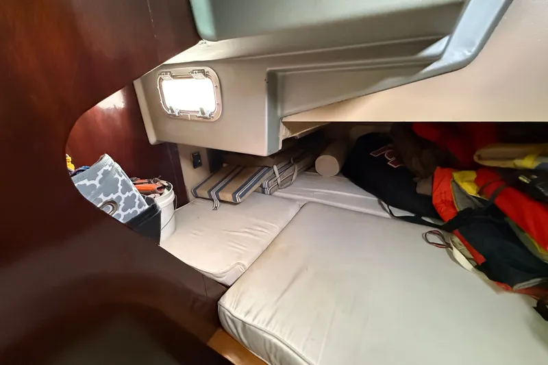 Slide: The Image of Cozy cabin interior of 1990 Beneteau First 35s5 sailboat with cushions and storage. - 64
