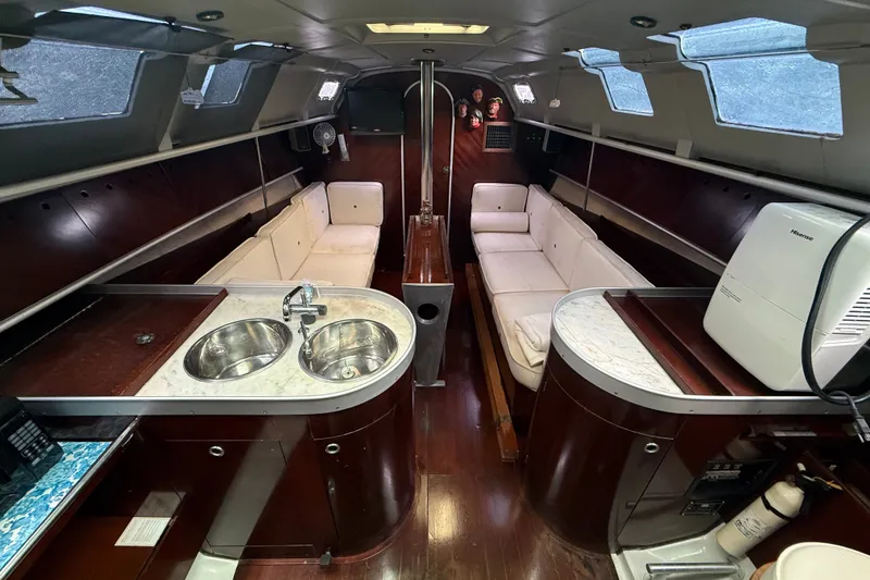 Slide: The Image of Interior of 1990 Beneteau First 35s5 yacht with modern kitchen and cozy seating. - 54