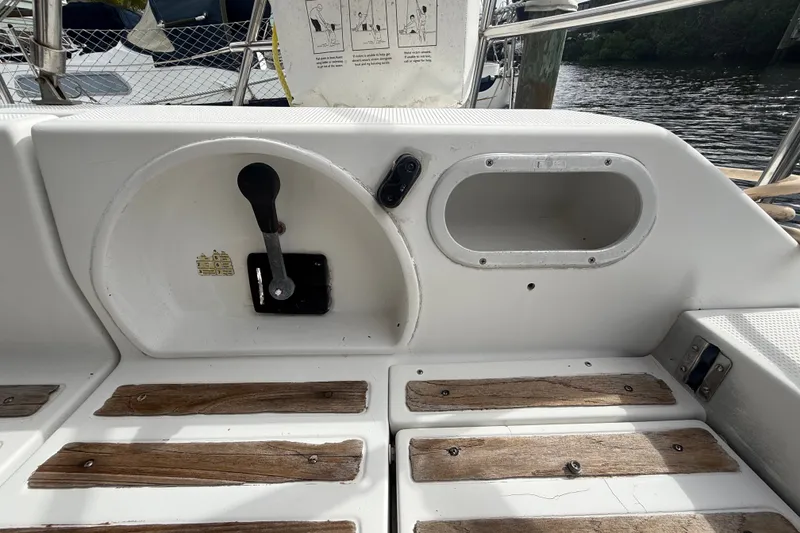 Slide: The Image of Cockpit of 1990 Beneteau First 35s5 sailboat with control lever and wooden flooring. - 9