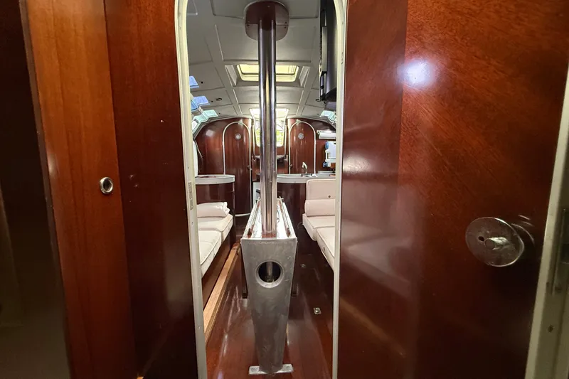 Slide: The Image of Interior view of 1990 Beneteau First 35s5 sailboat with polished wood and seating area. - 96