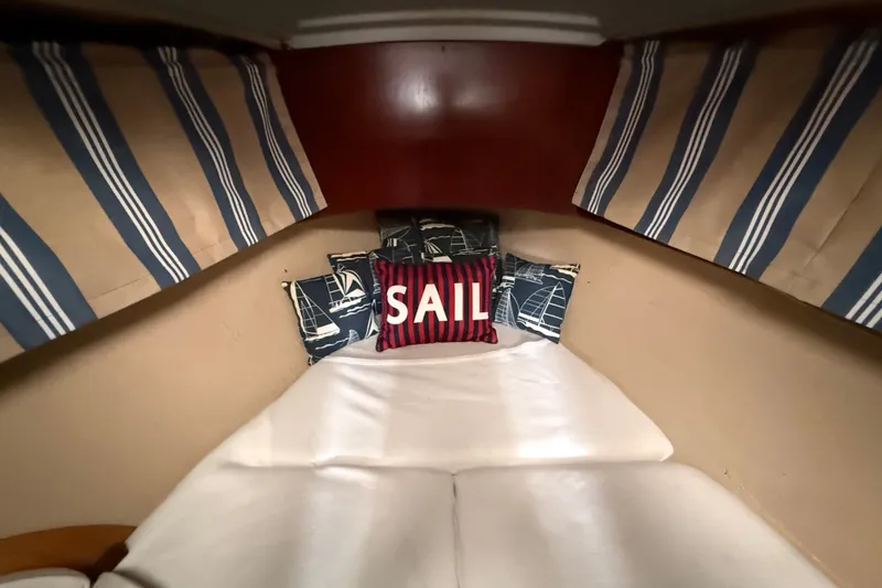 Slide: The Image of Cozy cabin interior of 1990 Beneteau First 35s5 sailboat with nautical-themed decor. - 93