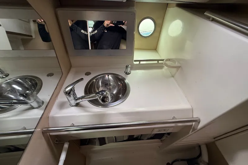 Slide: The Image of Interior of 1990 Beneteau First 35s5 yacht bathroom with sink and mirror. - 78