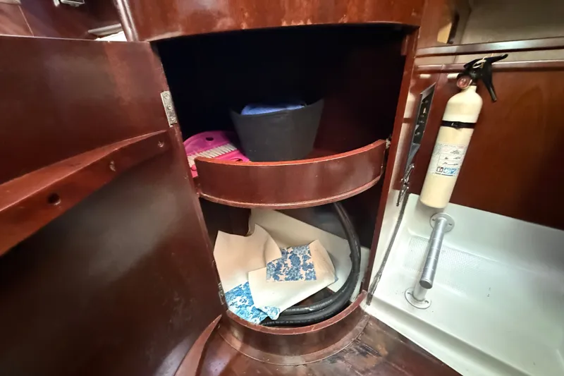 Slide: The Image of Interior storage of 1990 Beneteau First 35s5 sailboat with fire extinguisher and supplies. - 72