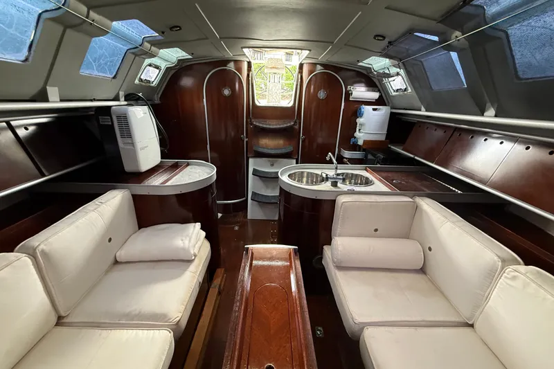 Slide: The Image of Interior of 1990 Beneteau First 35s5 yacht with elegant wood finish and cozy seating. - 98