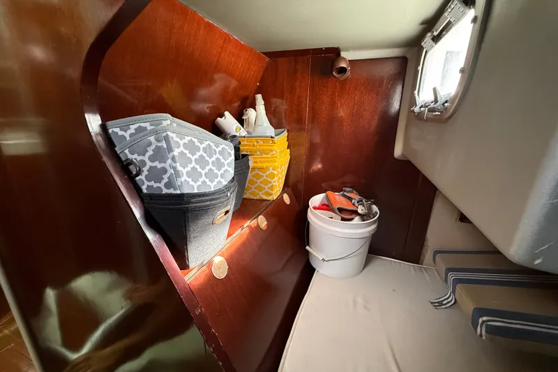 Slide: The Image of Interior of 1990 Beneteau First 35s5 sailboat with storage baskets and porthole. - 65