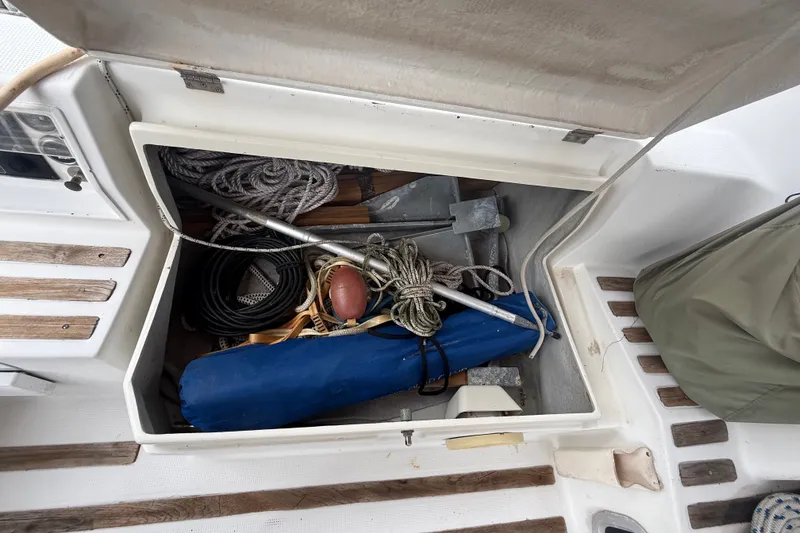 Slide: The Image of Storage compartment on a 1990 Beneteau First 35s5 sailboat with ropes and equipment. - 15