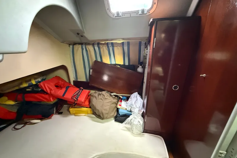 Slide: The Image of Interior cabin of a 1990 Beneteau First 35s5 sailboat with storage and life jackets. - 62