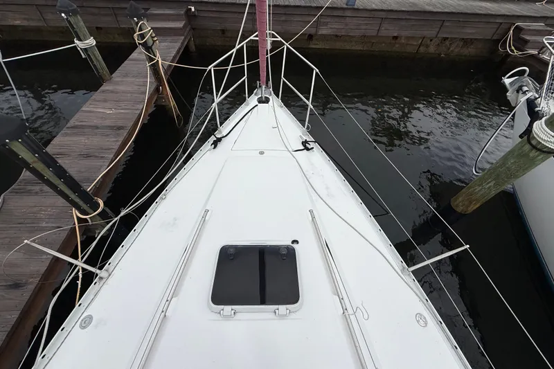 Slide: The Image of Deck view of a 1990 Beneteau First 35s5 sailboat docked at a marina. - 30