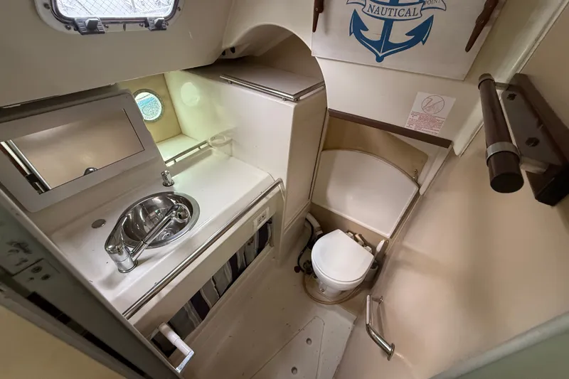 Slide: The Image of Compact bathroom in a 1990 Beneteau First 35s5 sailboat, featuring sink and toilet. - 77