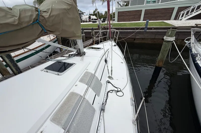 Slide: The Image of 1990 Beneteau First 35s5 sailboat docked, showcasing deck and rigging details. - 25