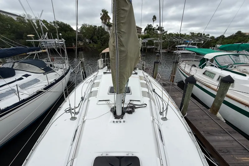 Slide: The Image of 1990 Beneteau First 35s5 sailboat docked, view from deck, surrounded by other boats. - 36