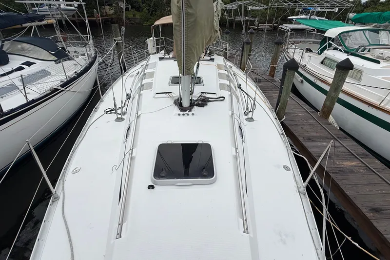 Slide: The Image of 1990 Beneteau First 35s5 sailboat docked, view of deck and surrounding boats. - 35