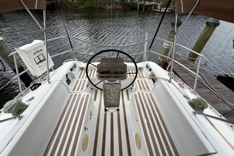 Slide: The Image of Cockpit of 1990 Beneteau First 35s5 sailboat with wooden deck and steering wheel. - 44
