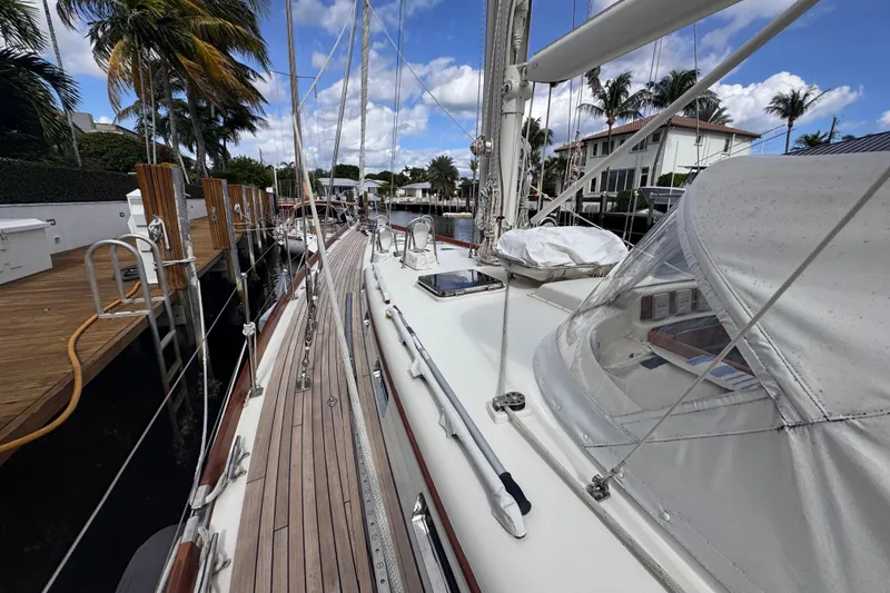 Slide: The Image of 1989 Little Harbor Sloop 58' docked, showcasing deck and rigging under clear skies. - 36