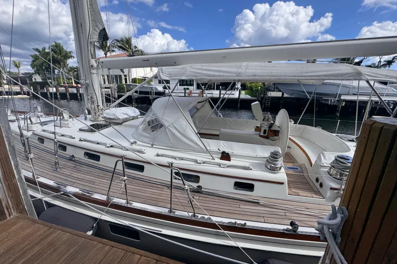 Slide: The Image of 1989 Little Harbor Sloop 58' sailboat docked, featuring sleek design and spacious deck. - 5
