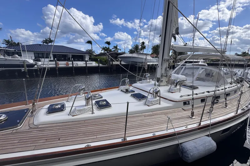 Slide: The Image of 1989 Little Harbor Sloop 58' yacht docked, showcasing sleek design and polished deck. - 4