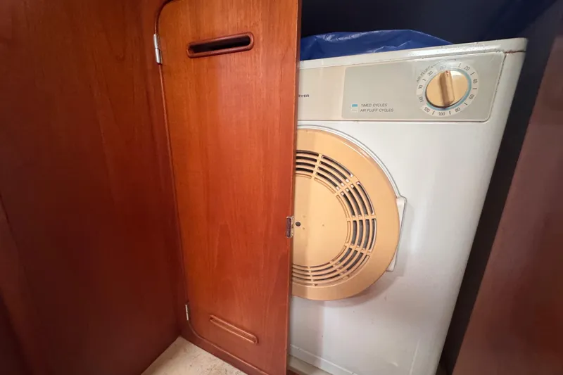 Slide: The Image of Laundry area inside 1989 Little Harbor Sloop 58', featuring a compact dryer. - 71