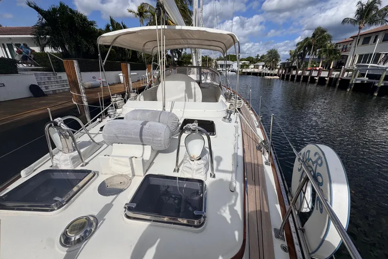 Slide: The Image of 1989 Little Harbor Sloop 58' docked, showcasing deck and cockpit under sunny skies. - 17