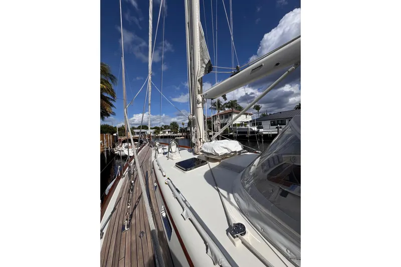 Slide: The Image of 1989 Little Harbor Sloop 58' sailboat docked under a blue sky. - 105