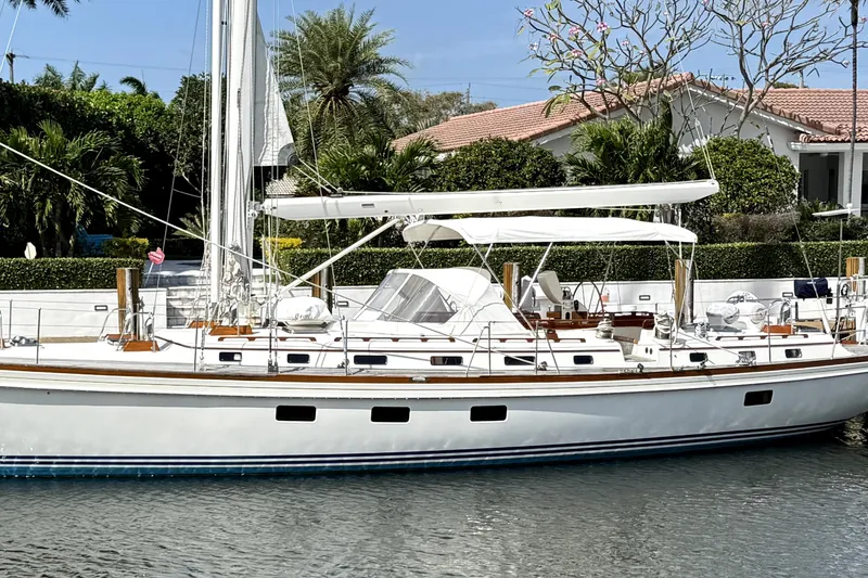 The Image of 1989 Little Harbor Sloop 58' yacht docked by a waterfront home. - 0