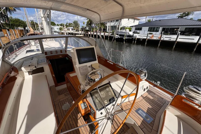 Slide: The Image of 1989 Little Harbor Sloop 58' yacht cockpit with steering wheel and navigation equipment. - 100