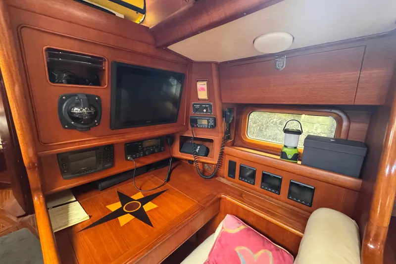 Slide: The Image of 1989 Little Harbor Sloop 58' interior with navigation equipment and wooden finish. - 64