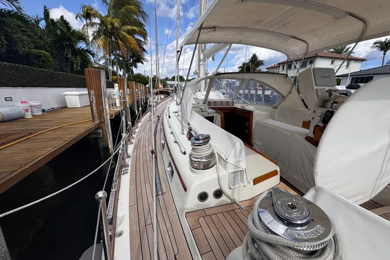 Slide: The Image of 1989 Little Harbor Sloop 58' docked, showcasing deck and cockpit under sunny skies. - 34