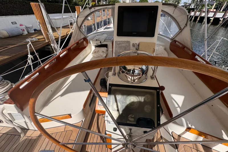 Slide: The Image of Cockpit of a 1989 Little Harbor Sloop 58' with wooden steering wheel and navigation instruments. - 99