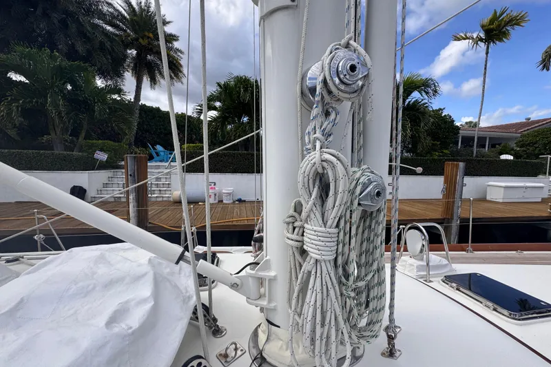 Slide: The Image of 1989 Little Harbor Sloop - 58' sailboat mast with rigging, docked near palm trees. - 30