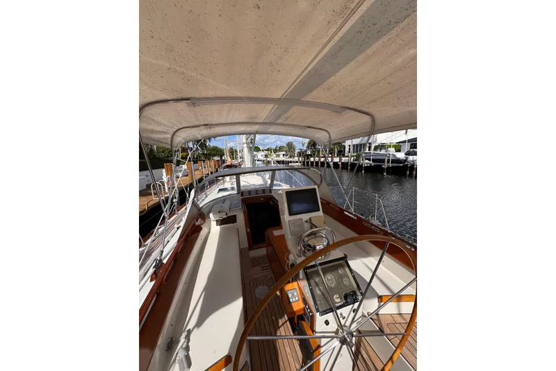 Slide: The Image of 1989 Little Harbor Sloop 58' yacht cockpit with steering wheel and navigation equipment. - 102