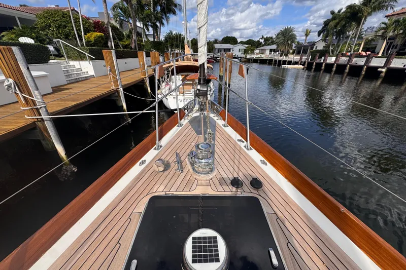 Slide: The Image of 1989 Little Harbor Sloop 58' docked, showcasing teak deck and polished fittings. - 38