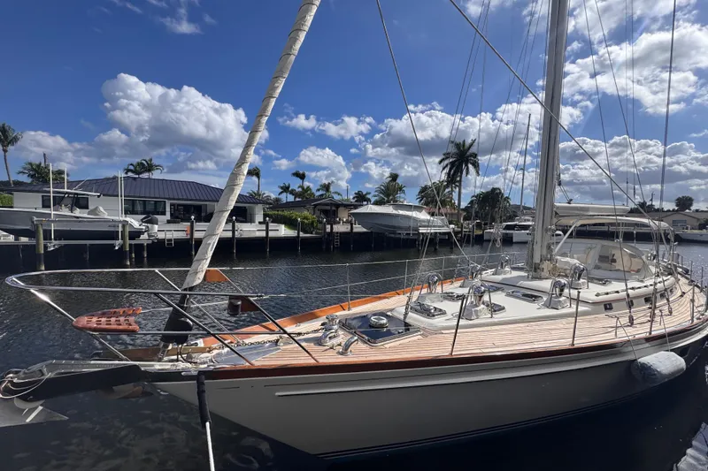Slide: The Image of 1989 Little Harbor Sloop 58' docked, showcasing elegant design and clear skies. - 1