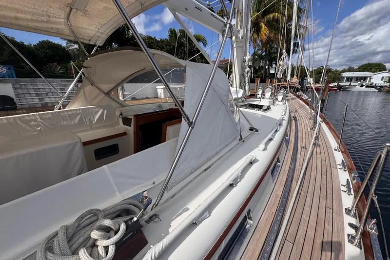 Slide: The Image of 1989 Little Harbor Sloop 58' with teak deck, docked in a marina under blue skies. - 25