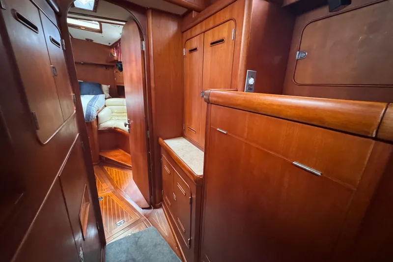 Slide: The Image of Interior of 1989 Little Harbor Sloop 58' with wooden cabinetry and cozy seating area. - 69