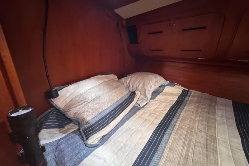 Slide: The Image of Cozy cabin interior of 1989 Little Harbor Sloop 58' with striped bedding. - 73