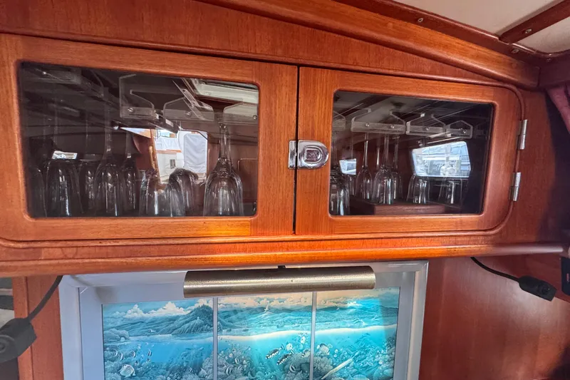 Slide: The Image of Wooden cabinet with glassware in a 1989 Little Harbor Sloop - 58' yacht interior. - 92