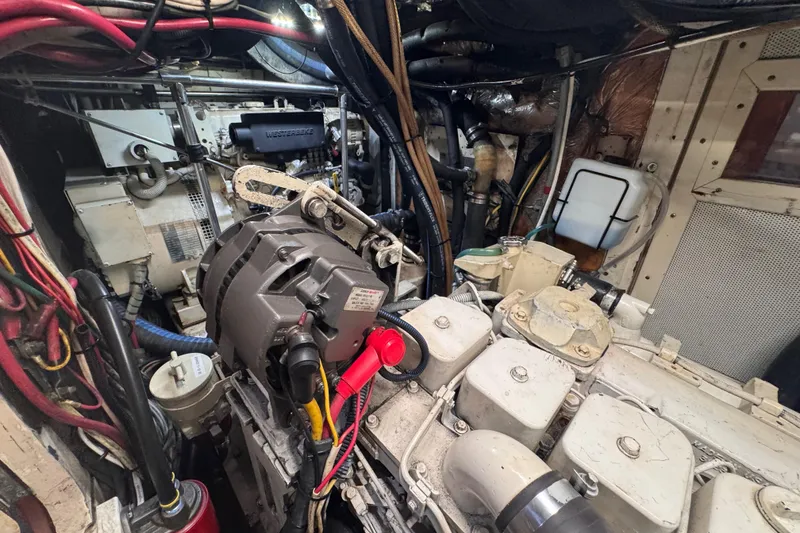 Slide: The Image of Engine room of a 1989 Little Harbor Sloop 58' with visible machinery and wiring. - 93