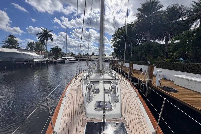 Slide: The Image of 1989 Little Harbor Sloop 58' docked, surrounded by palm trees and a clear blue sky. - 40