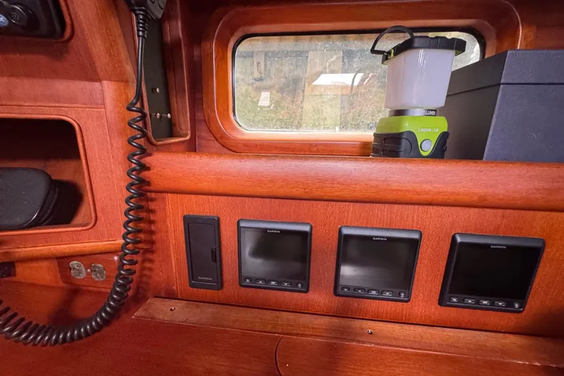 Slide: The Image of Interior of 1989 Little Harbor Sloop, featuring navigation instruments and wooden paneling. - 65