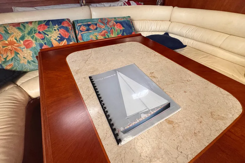 Slide: The Image of 1989 Little Harbor Sloop 58' manual on a yacht's elegant wooden table. - 53