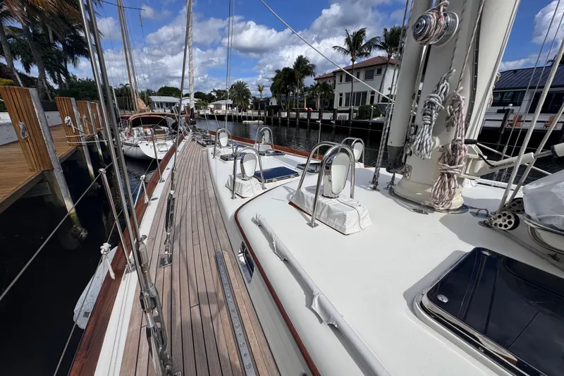Slide: The Image of 1989 Little Harbor Sloop 58' docked, showcasing deck and rigging under a blue sky. - 37