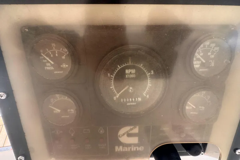 Slide: The Image of Instrument panel of a 1989 Little Harbor Sloop 58', featuring RPM, oil, and temperature gauges. - 21