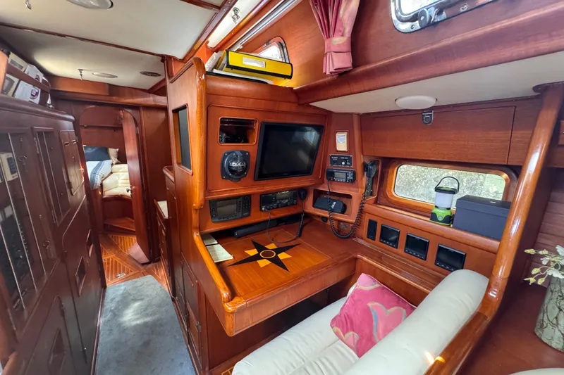 Slide: The Image of 1989 Little Harbor Sloop 58' interior with navigation station and cozy seating area. - 90