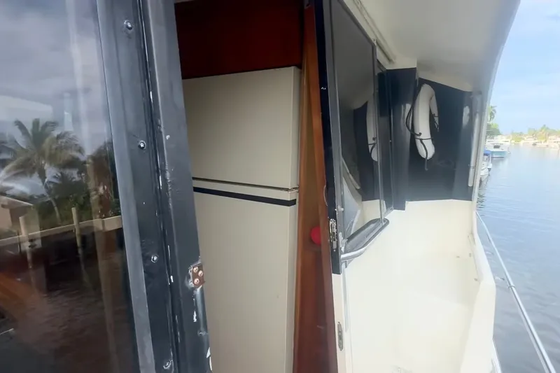 Slide: The Image of 1989 Ocean Yachts 48 Motor Yacht exterior with open door and water view. - 11
