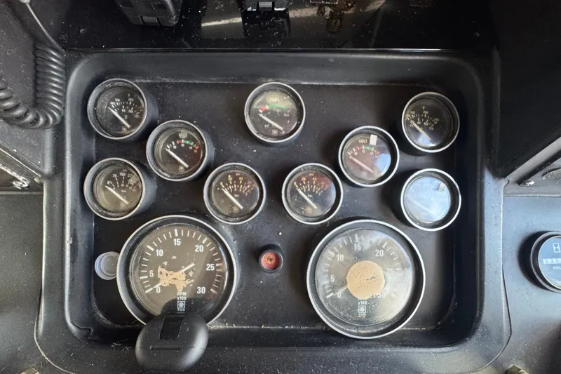 Slide: The Image of Control panel of a 1989 Ocean Yachts 48 Motor Yacht with various gauges and dials. - 78