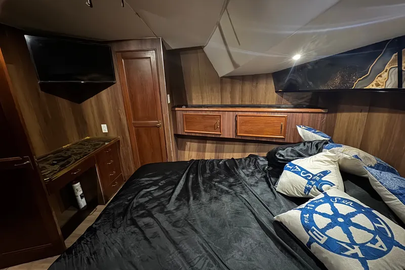 Slide: The Image of Luxurious cabin interior of 1989 Ocean Yachts 48 Motor Yacht with wood paneling and nautical decor. - 89