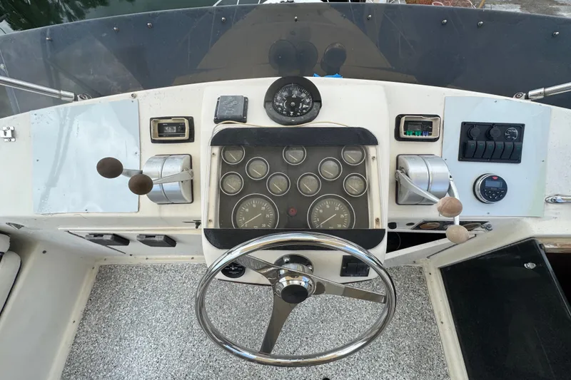 Slide: The Image of 1989 Ocean Yachts 48 Motor Yacht helm with steering wheel and control panel. - 111