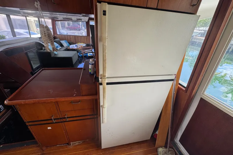 Slide: The Image of Interior of 1989 Ocean Yachts 48 Motor Yacht with refrigerator and wooden cabinetry. - 73