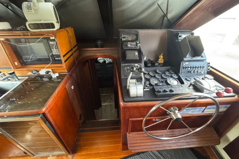 Slide: The Image of 1989 Ocean Yachts 48 Motor Yacht helm with navigation instruments and wooden cabinetry. - 86
