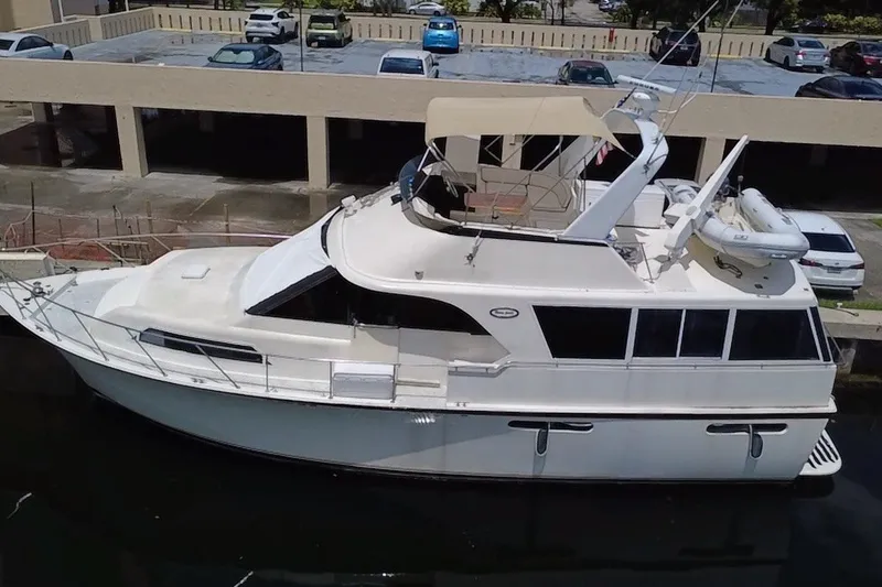 Slide: The Image of 1989 Ocean Yachts 48 Motor Yacht docked, featuring spacious deck and flybridge. - 129